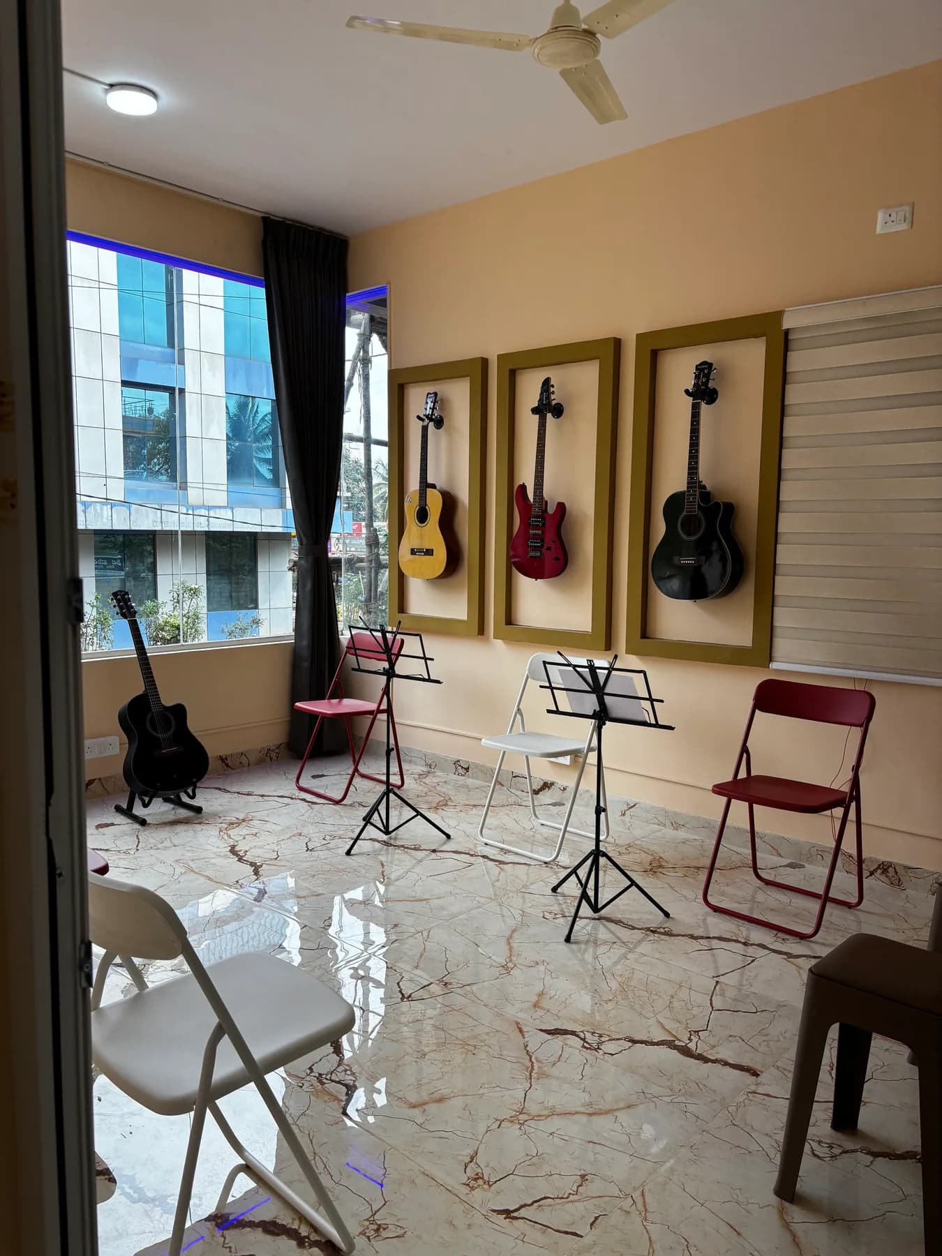 Guitar classroom with instruments displayed on the wall